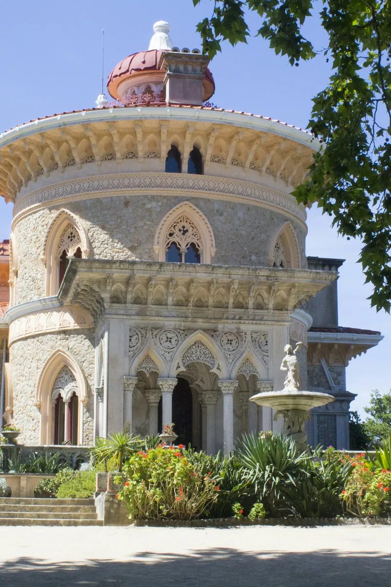 Monserrate Palace - the pink Romantic palace with filigree arches and a central dome set among palms and lawns near Sintra, Portugal